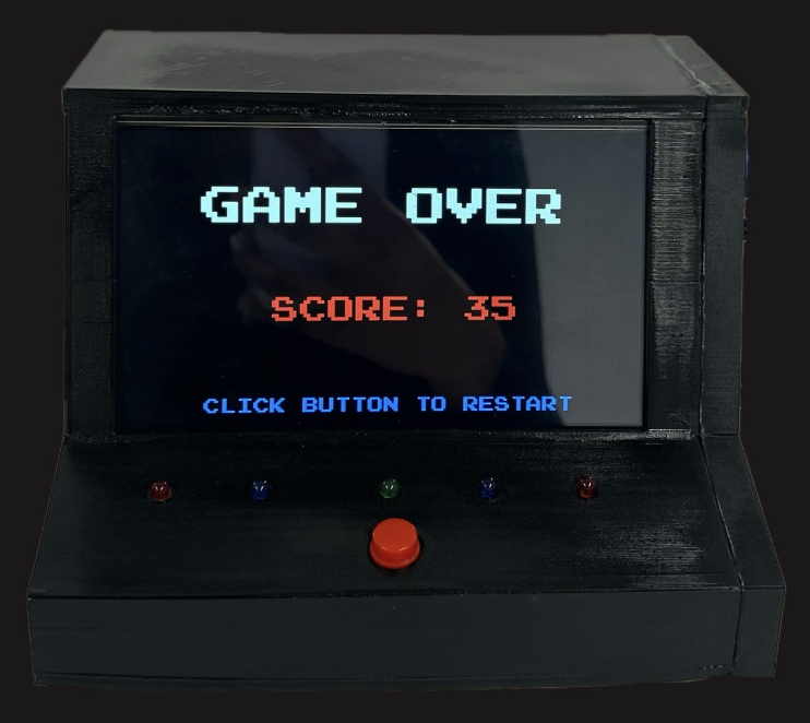 The finished black cabinet showing the Game Over screen with a score of 35, five LEDs and a red button